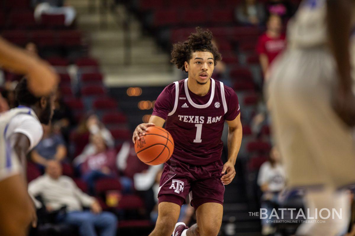 Sophomore guard Marcus Williams (1) looks for an open teammate in Reed Arena on Nov. 30, 2021.
