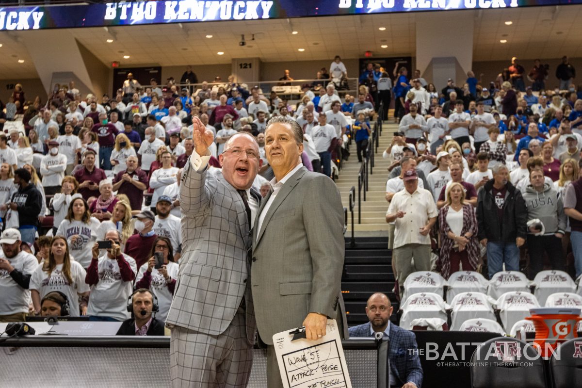 Texas A&M coach Buzz Williams and Kentucky coach John Calipari talking and posing for photos before tip off in Reed Arena on Wednesday, Jan. 19, 2022.