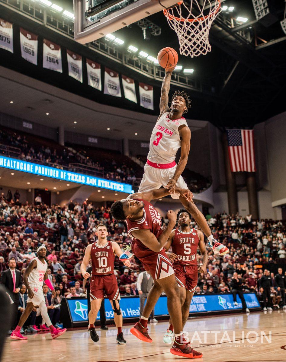 Graduate guard Quenton Jackson (3) attempts to jump over a South Carolina player to score.
