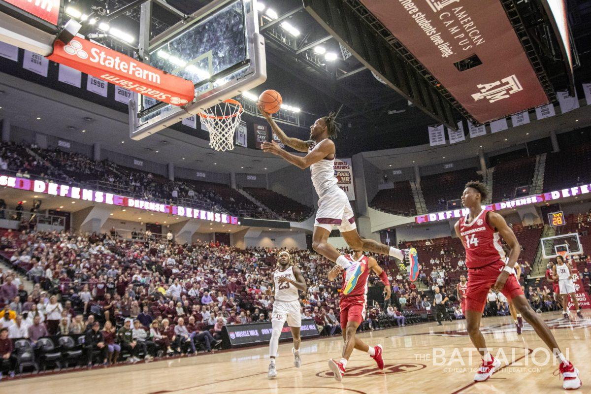 Fifth year guard Quenton Jackson (3) jumps for a layup on the Arkansas goal in the Aggies' game against the Razorbacks on Saturday, Jan. 8, 2022.