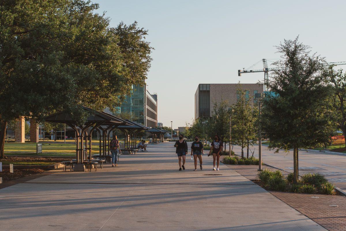 <p>Three students walk outside the Student Memorial Center (MSC)</p>