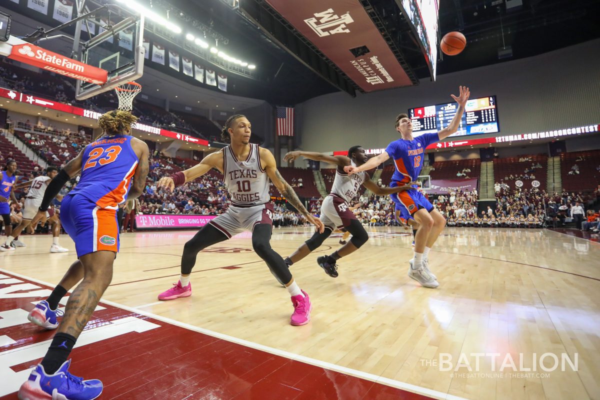 Guard Brandon McKissic (23) passes the ball to forward Colin Castleton (12) as senior forward Ethan Henderson (10) and sophomore guard Hassan Diarra (5) cover them in Reed Arena during the Aggies' game against the Gators on Tuesday, Feb. 15, 2022.