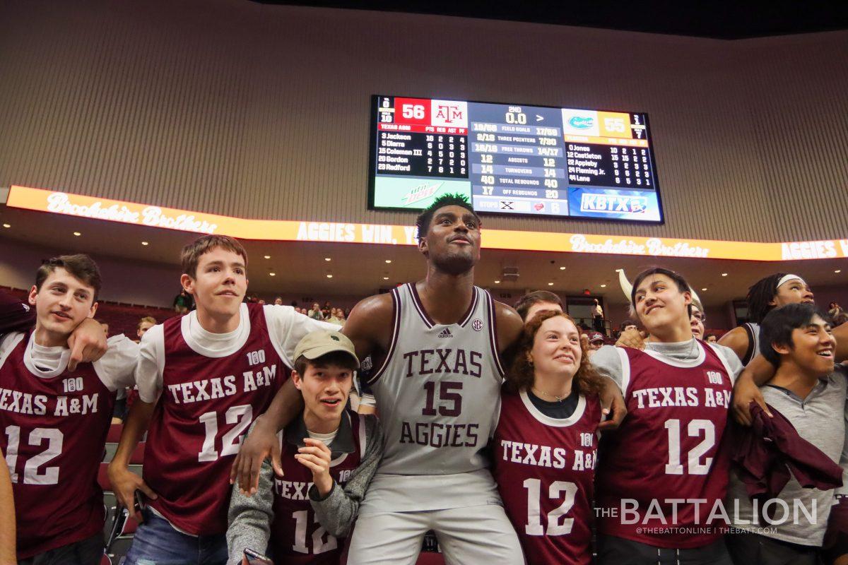 Sophomore guard Henry Coleman III (15) celebrates with the 12th Man after the Aggies victory over Florida in Reed Arena on Tuesday, Feb. 15, 2022.