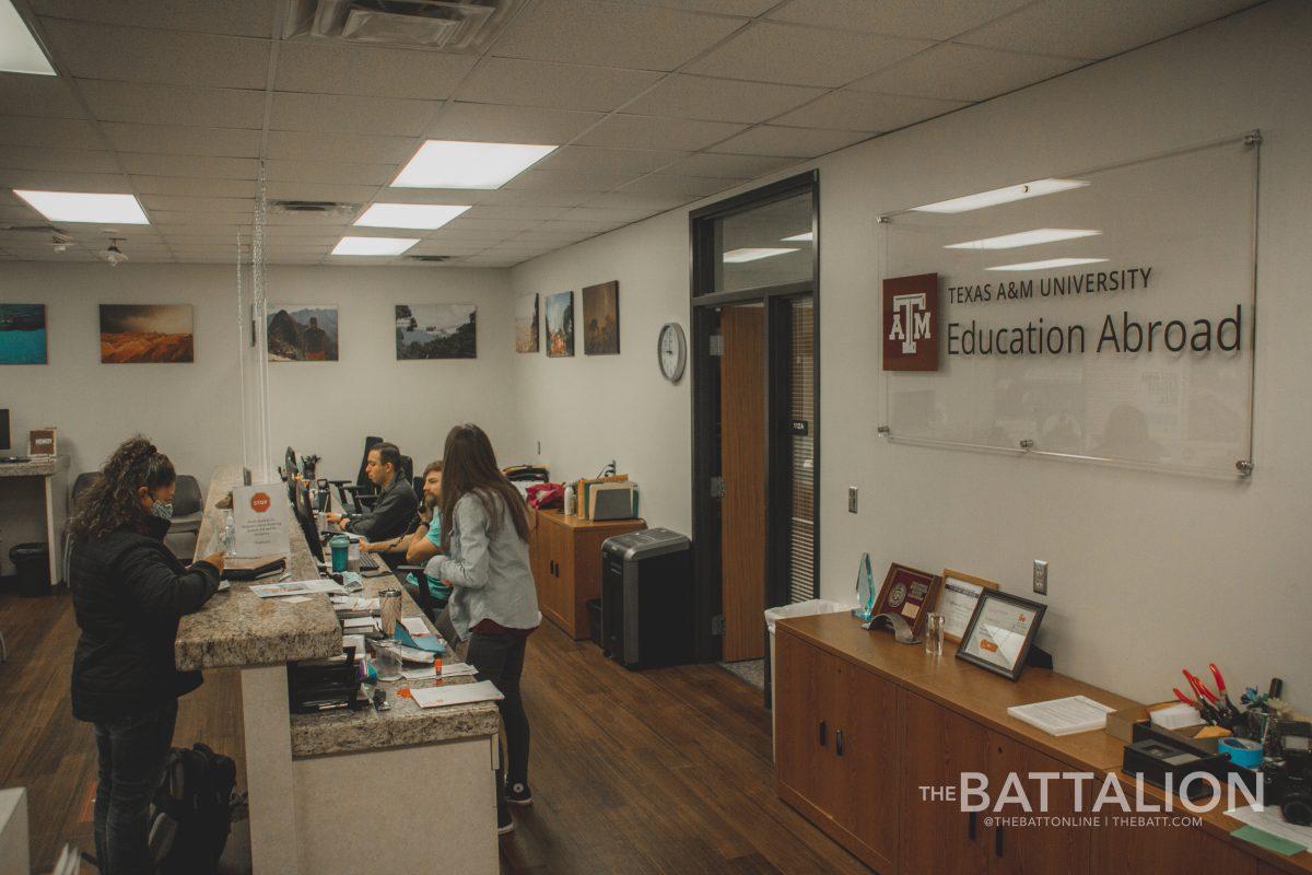 Workers of the education abroad program located inside the Pavilion building talk to students.&#160;