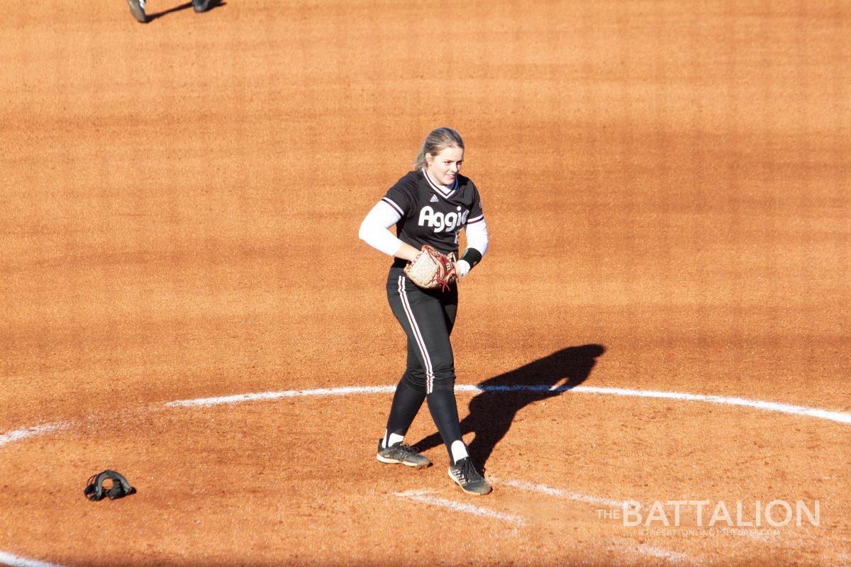 Senior pitcher and outfielder Makinzy Herzog (24) practices pitching in Davis Diamond on Friday, Feb. 18, 2022.