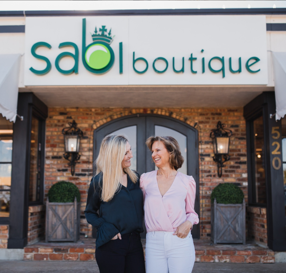 Sabi boutique founders stand outside their store. 