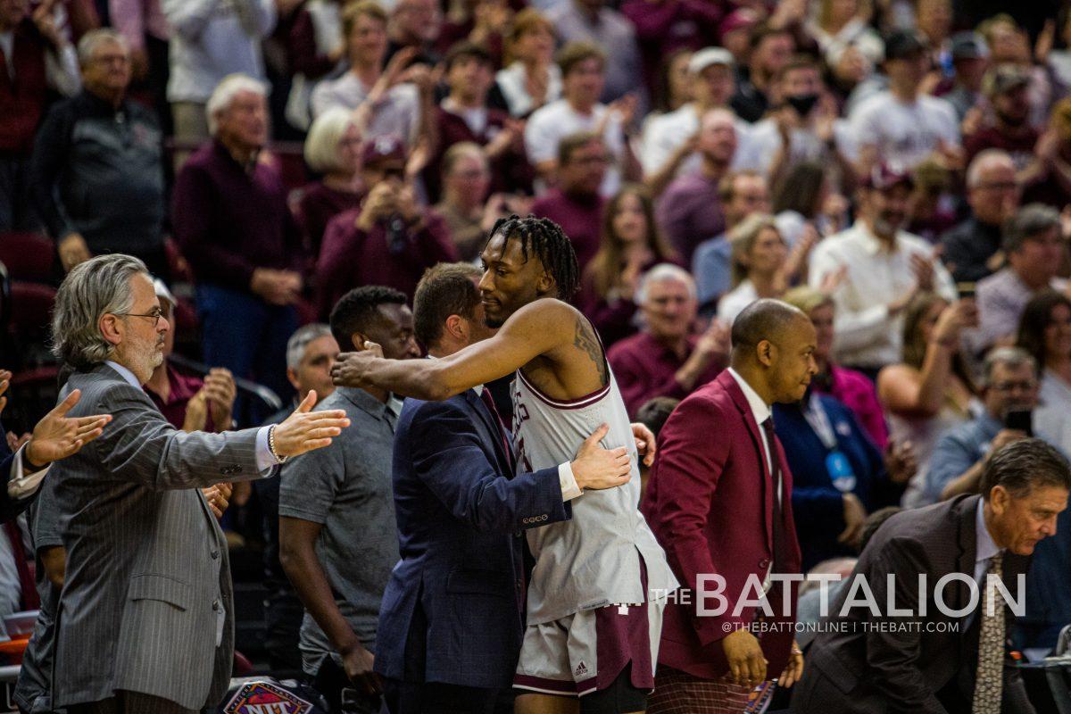 <p>Graduate <strong>Quenton Jackson </strong>(3) hugs his team after his last game at Reed Arena on Wednesday, March 23 in Reed Arena</p>