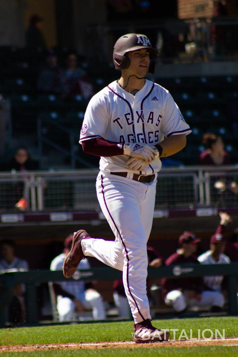 Graduate student catcher Troy Claunch (12) walks to first base at Olsen Field in Blue Bell Park on Saturday, March 12, 2022.