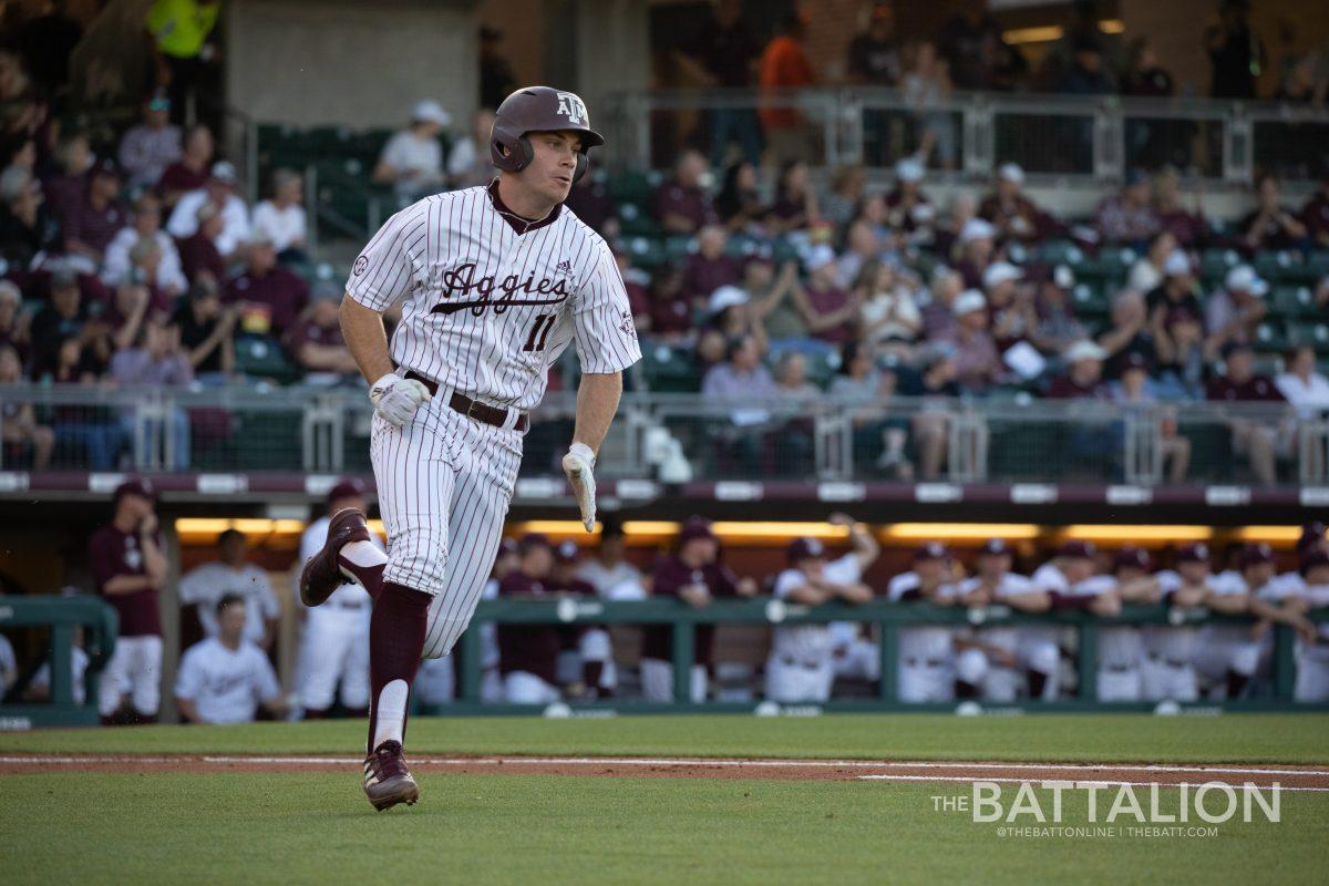 Junior second baseman Austin Bost (11) runs toward first base&#160;at Olsen Field in Blue Bell Park on Friday, March 25, 2022.