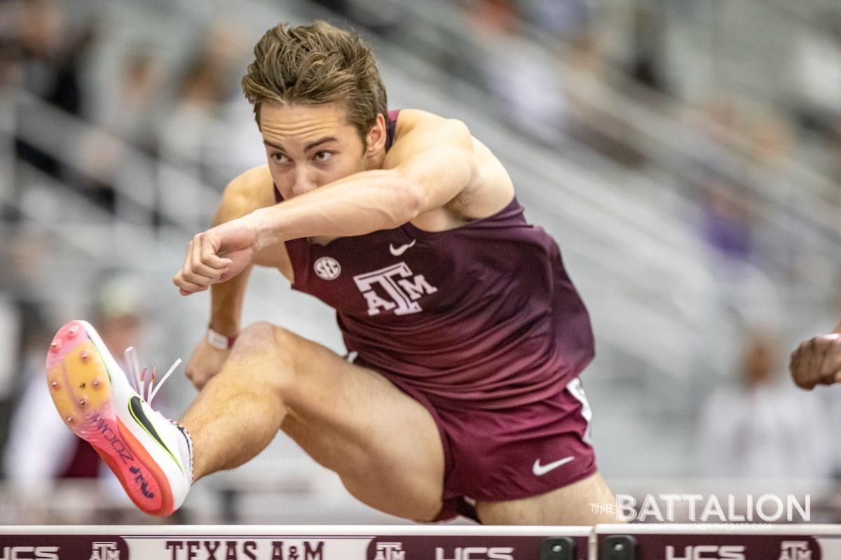 Junior Connor Schulman midair during the 60-meter hurdle competition on Feb. 5, 2022.