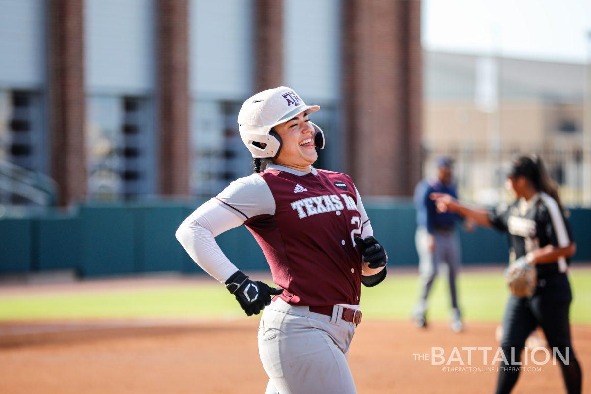 Senior catcher Haley Lee&#160;smiles as she runs towards second base.&#160;