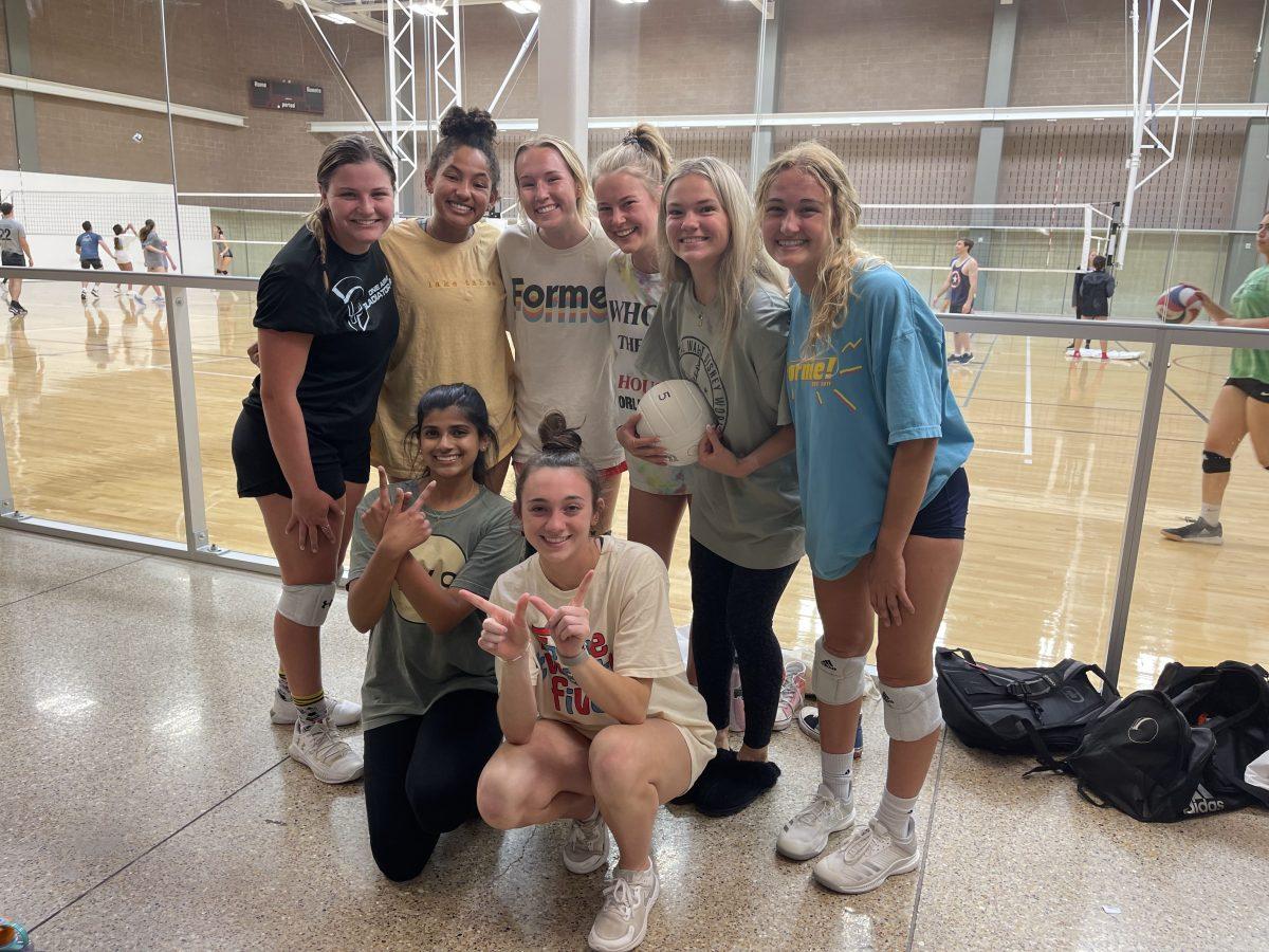 The womens competitive volleyball intramural team Bark pose in front of court 5B in the Student Recreation Center after winning the semifinals game against Queens of the Court.