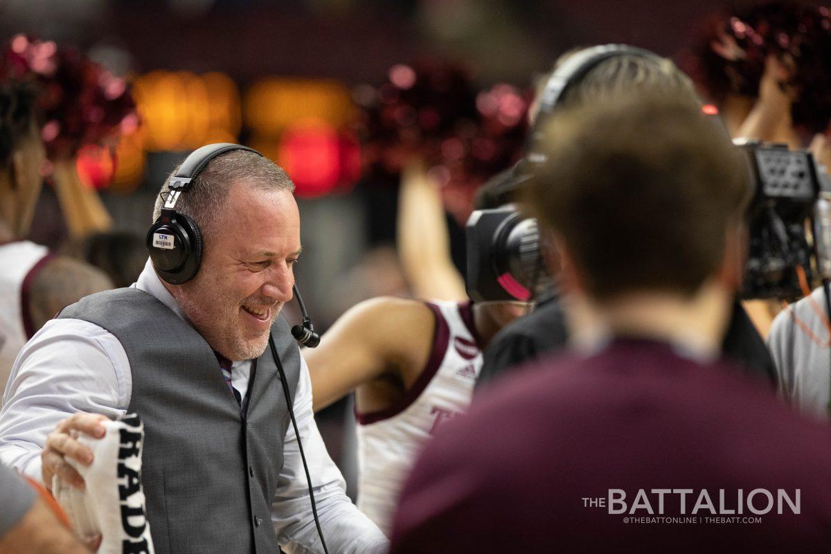 Texas A&amp;M head coach Buzz Williams is congraulated by his players during his postgame interview.