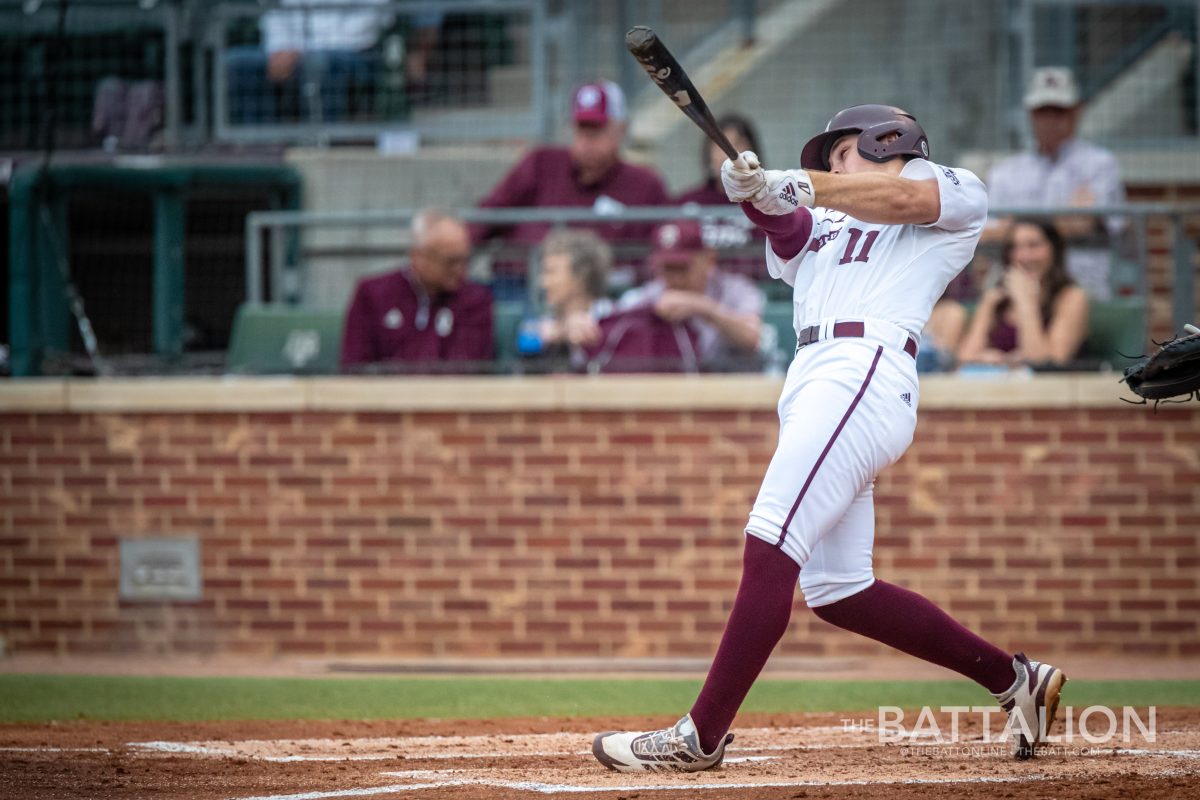 <p>Junior second baseman Austin Bost (11) hits a home run in the third inning of the Aggies' game against the Patriots on Tuesday, April 19, 2022.</p>