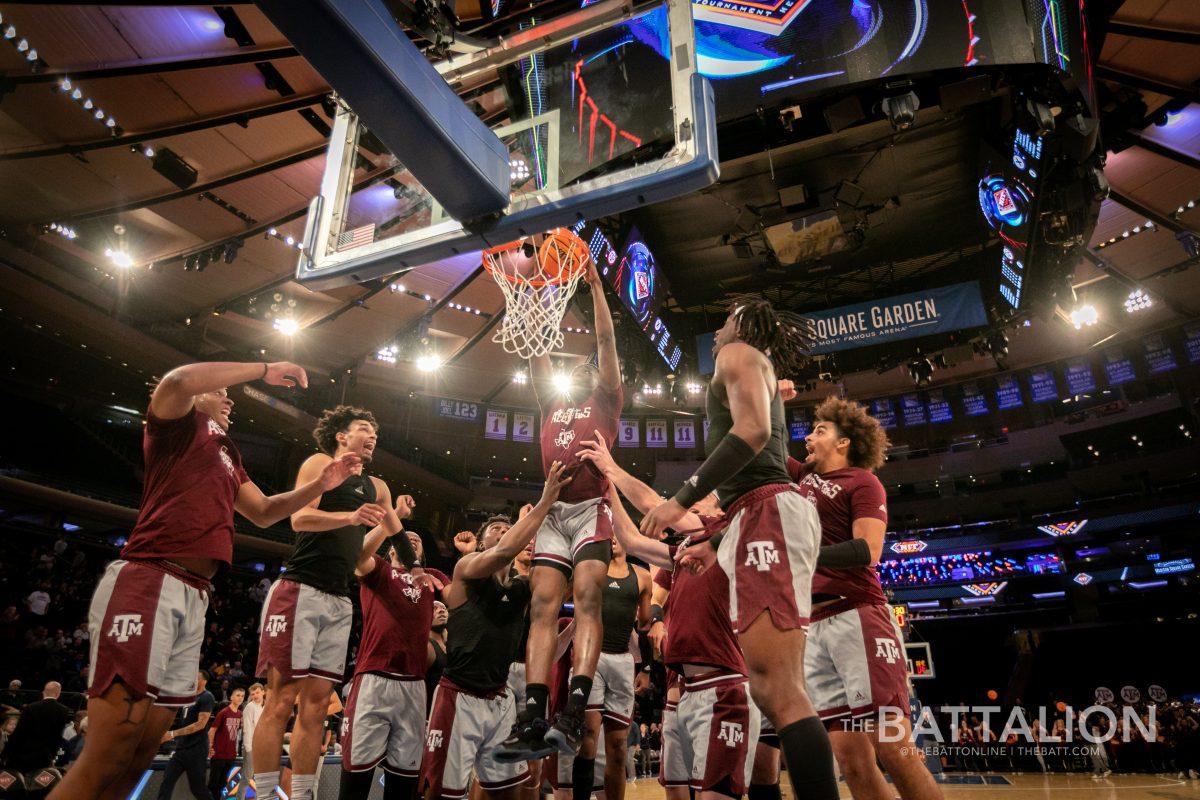 Sophomore guard Hassan Diarra (5) is lifted up by his teammates to dunk in Madison Square Garden on Thursday, Mar. 31, 2022.