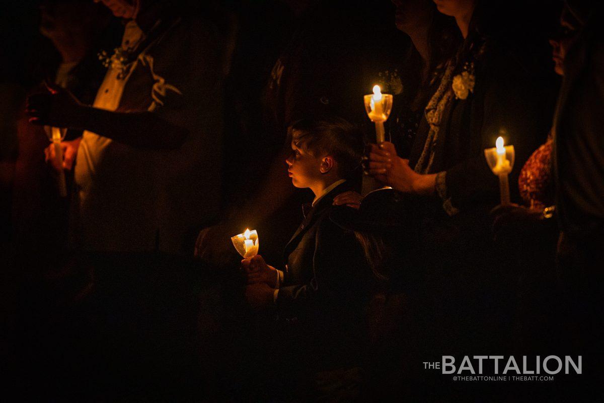 Samuel Gentry, son of Jason Robert Gentry, holds a candle during Muster, a ceremony held every year to honor the passing of current and former TAMU students, in Reed Arena on Thursday, April 21, 2022.