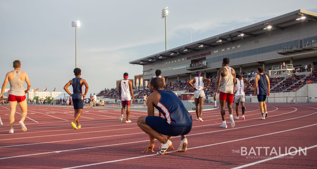 Sprinters rest after the men's 100m at E.B. Cushing Stadium on April 30, 2022.