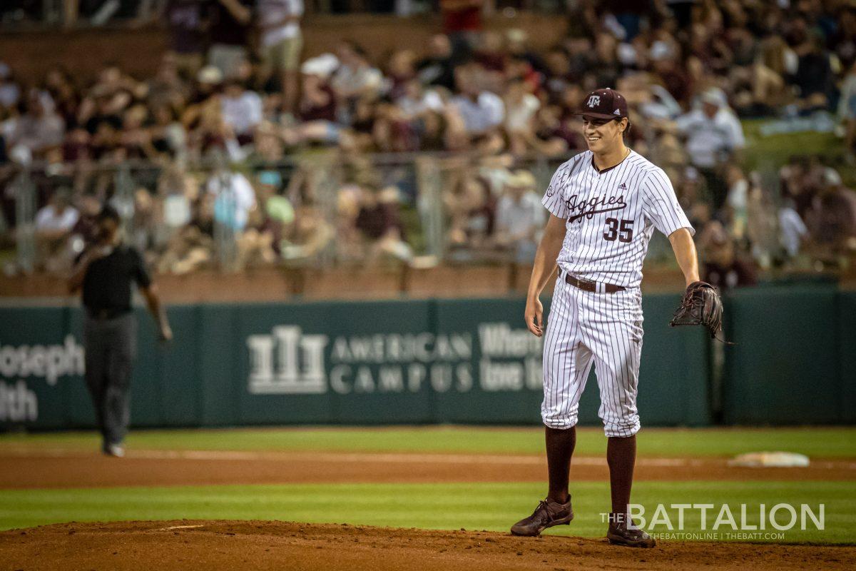 Sophomore pitcher Nathan Dettmer (35) smiles after catching a hit ball on the mound at Olsen Field on Friday, April 22, 2022.