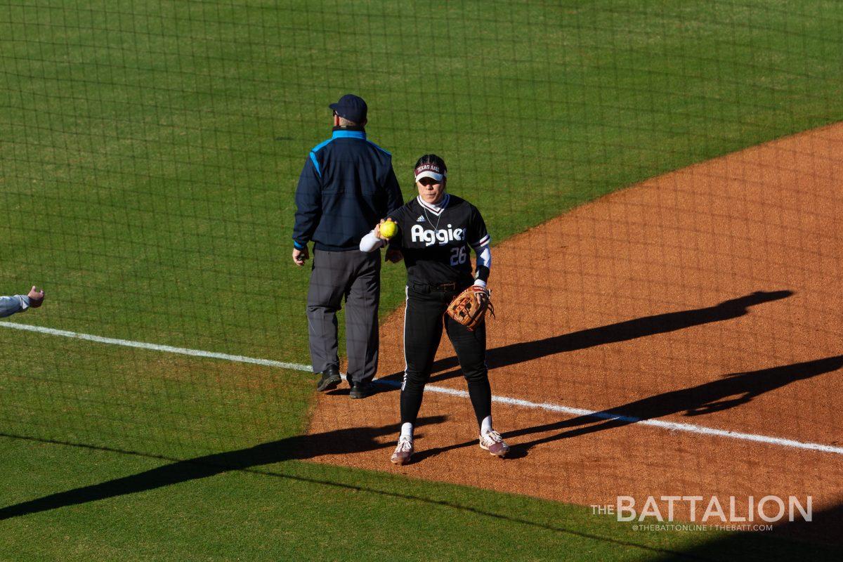 Sophomore infielder Trinity Cannon (26) catches a new game ball in Davis Diamond on Friday, Feb. 18, 2022.