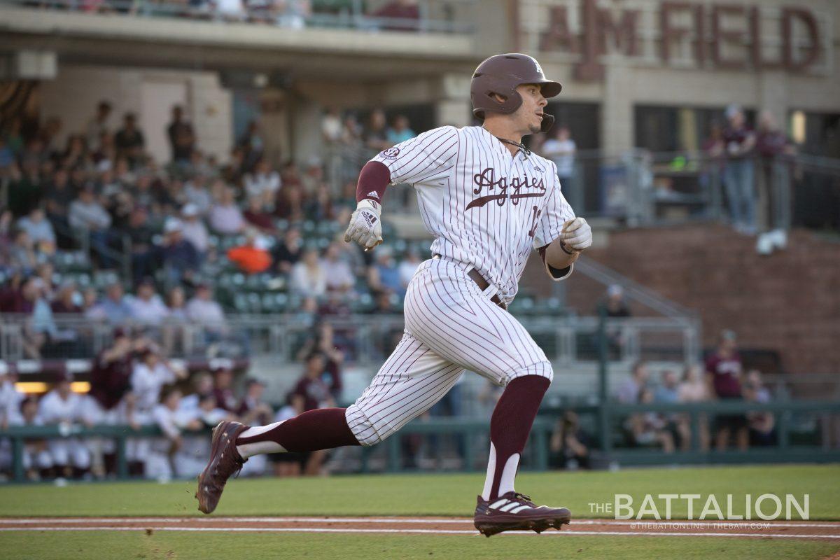 Senior catcher Troy Claunch (12) runs toward first base at Olsen Field in Blue Bell Park on Friday, March 25, 2022.