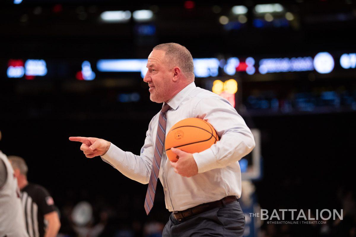 Texas A&M head coach Buzz Williams holds the game ball away from the referee until he explains a call that was fouled at Madison Square Garden on Thursday, Mar. 31, 2022.