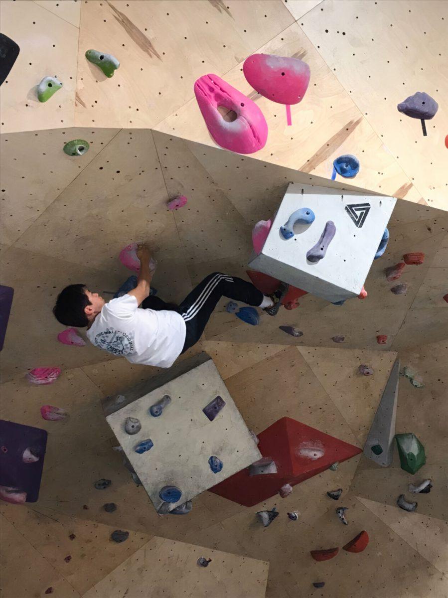 Biomedical sciences senior David Lee climbing the difficult cave wall at Stone Co. Climbing.