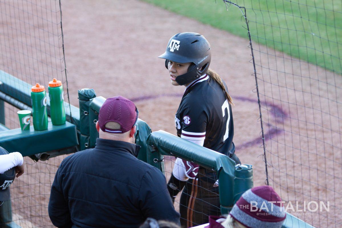 Freshman catcher and third baseman Katie Dack (7) talks with assistant coach Craig Snider in Davis Diamond on Friday, Feb. 18, 2022.