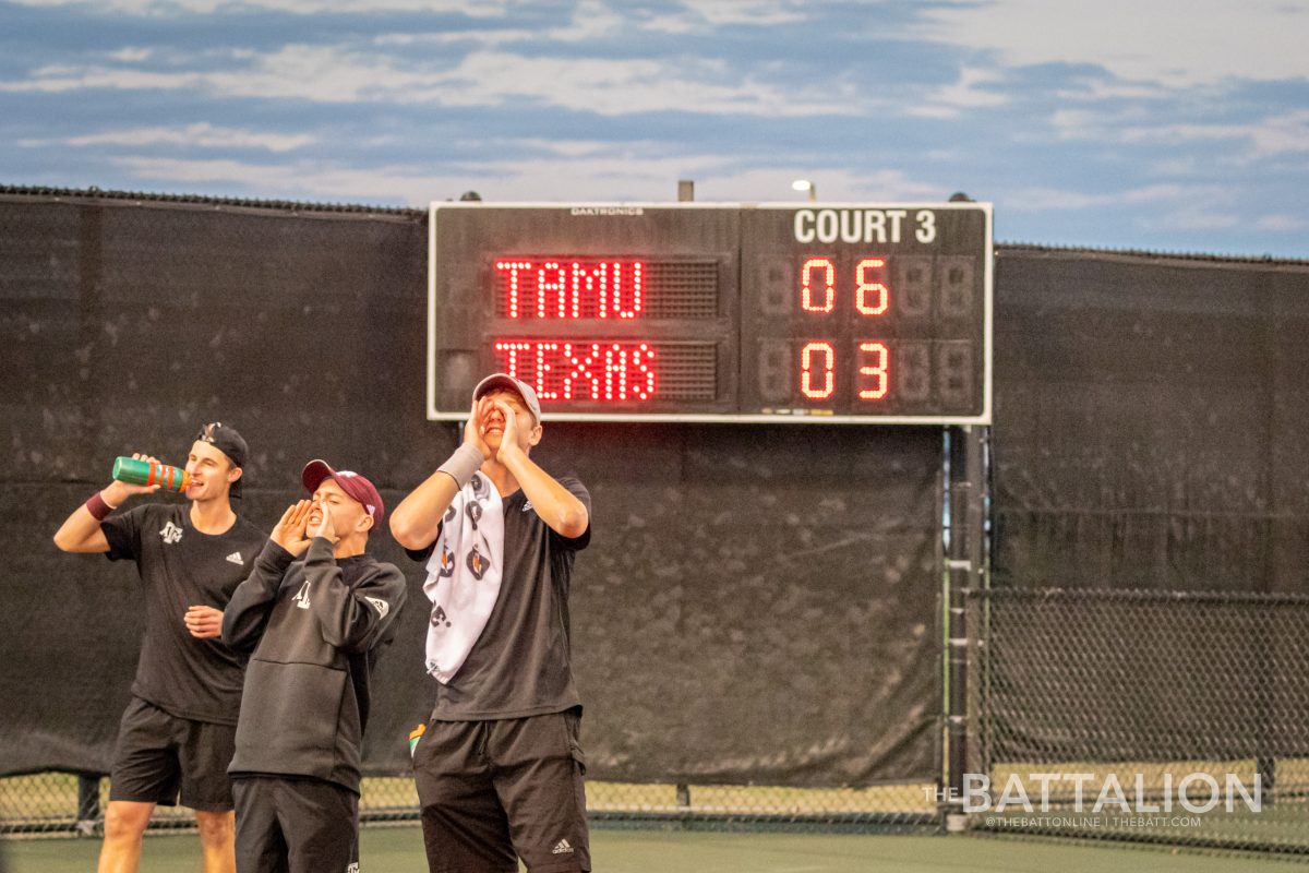 The Texas A&amp;M men's tennis team celebrates after sophomore Matthis Ross and freshman Stefan Storch won their doubles match against the University of Texas at the Mitchell Tennis Center on Wednesday, Mar. 9, 2022.