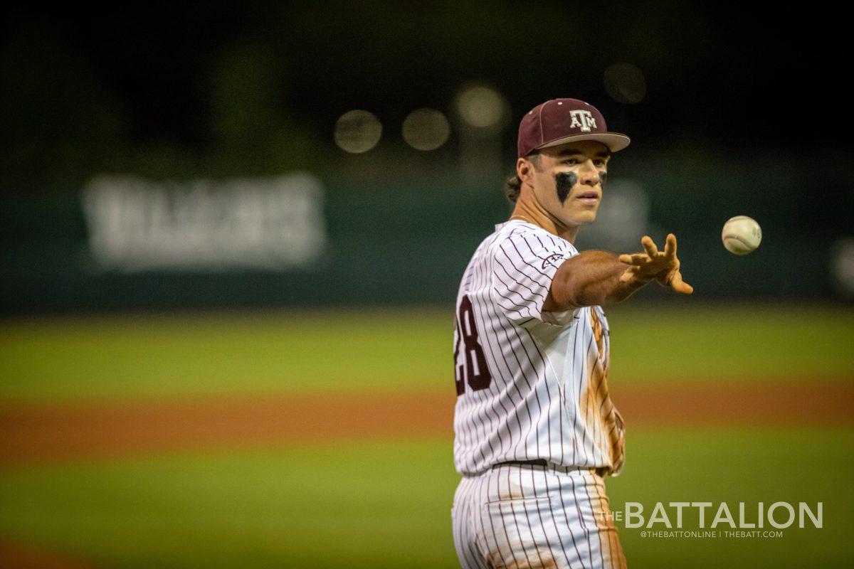 Sophomore third baseman Trevor Werner (28) throws a practice ball into the dugout at Olsen Field on Friday, April 22, 2022.