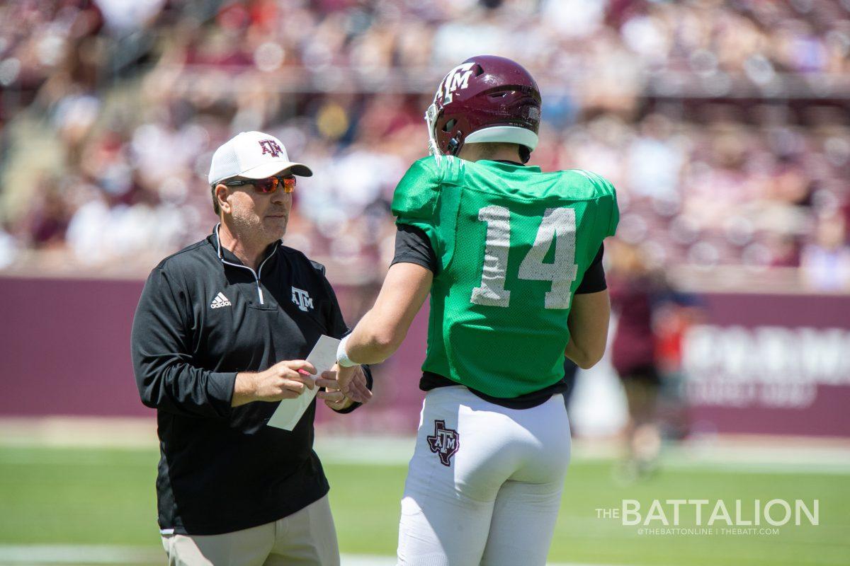 Junior QB Max Johnson (14) and coach Jimbo Fisher speak after Johnson ran on the previous play in Kyle Field on April 9, 2022.