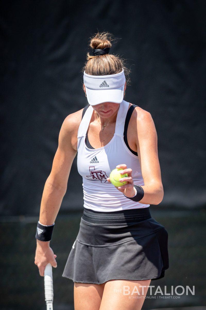 Junior Carson Branstine prepares to serve the ball during her singles match at the Mitchell Tennis Center on Saturday, May 7, 2022.