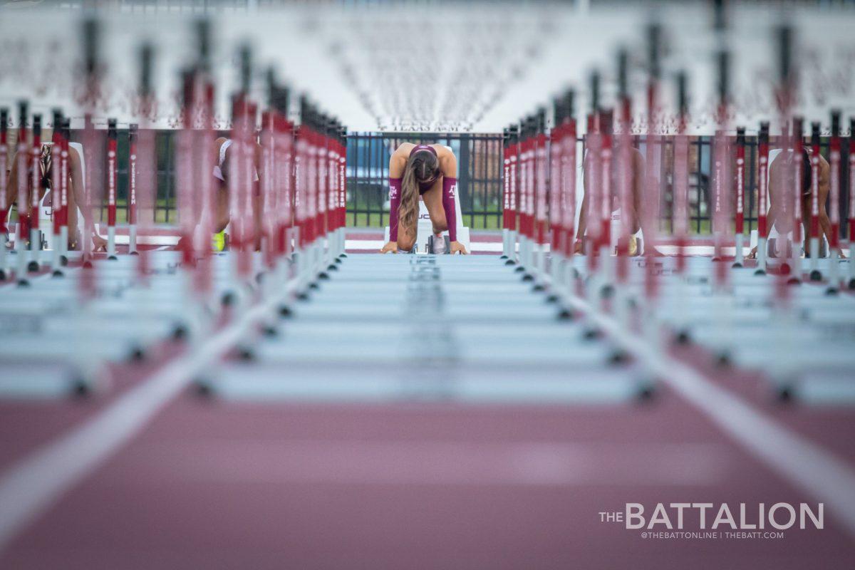 Fifth-year Kennedy Smith takes her mark on the starting block before the womens 100m hurdles at the Alumni Muster meet on Saturday, April 30, 2022.