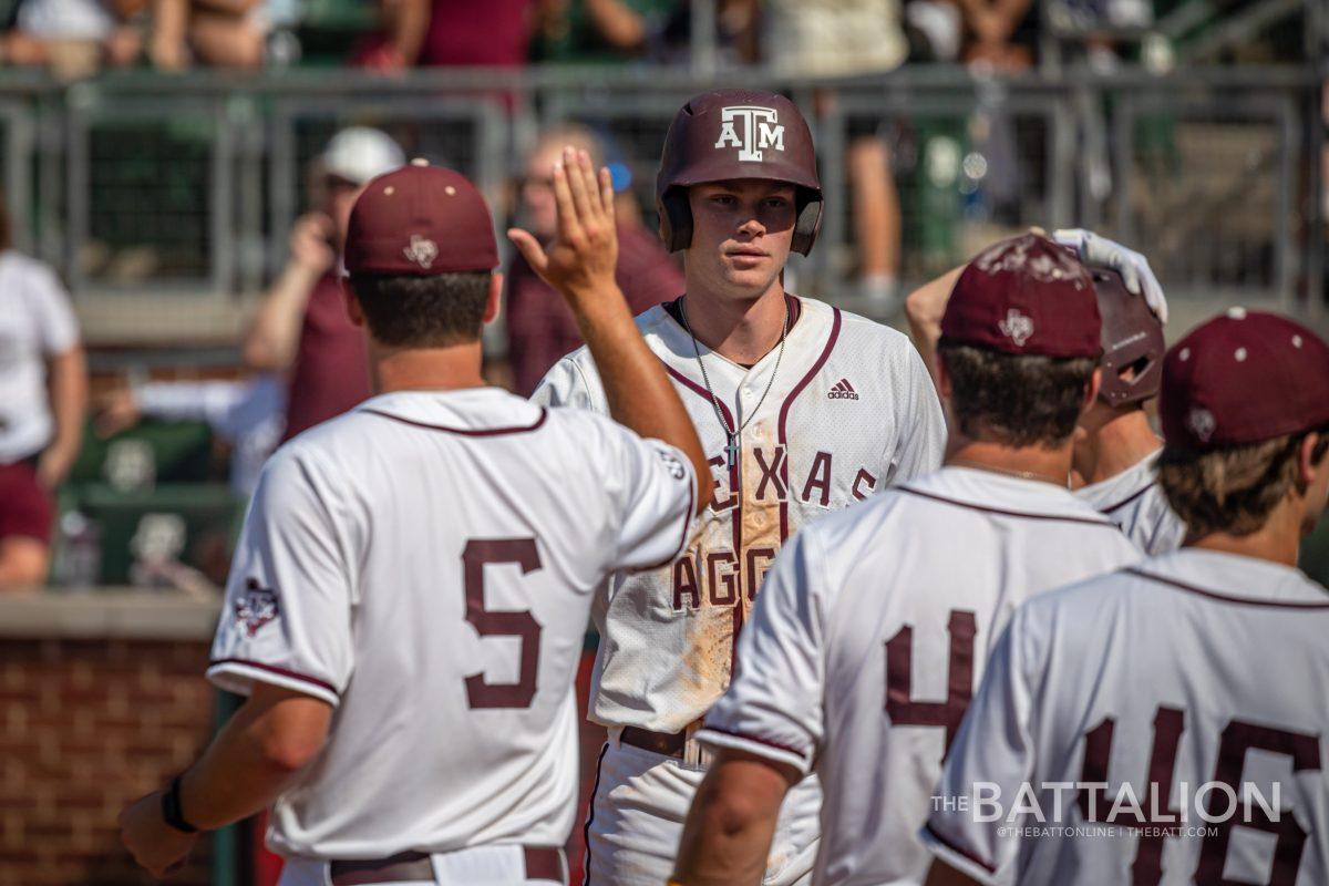 Junior OF Brett Minnich (23) walks back to the dugout after scoring a run during the Aggies game against Mississippi State at Olsen Field on Saturday, May 14, 2022.