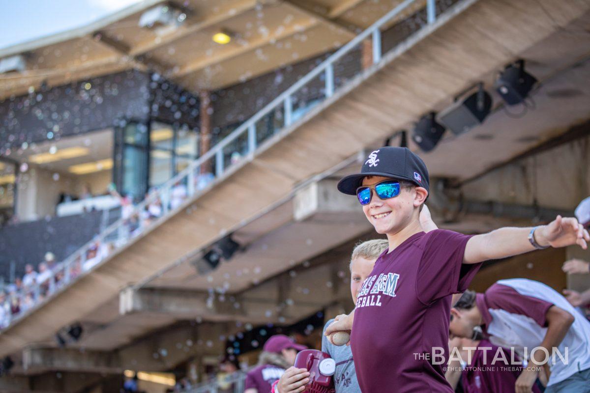 A young fan celebrates after the Aggies score a run against the Mississippi State Bulldogs at Olsen Field.