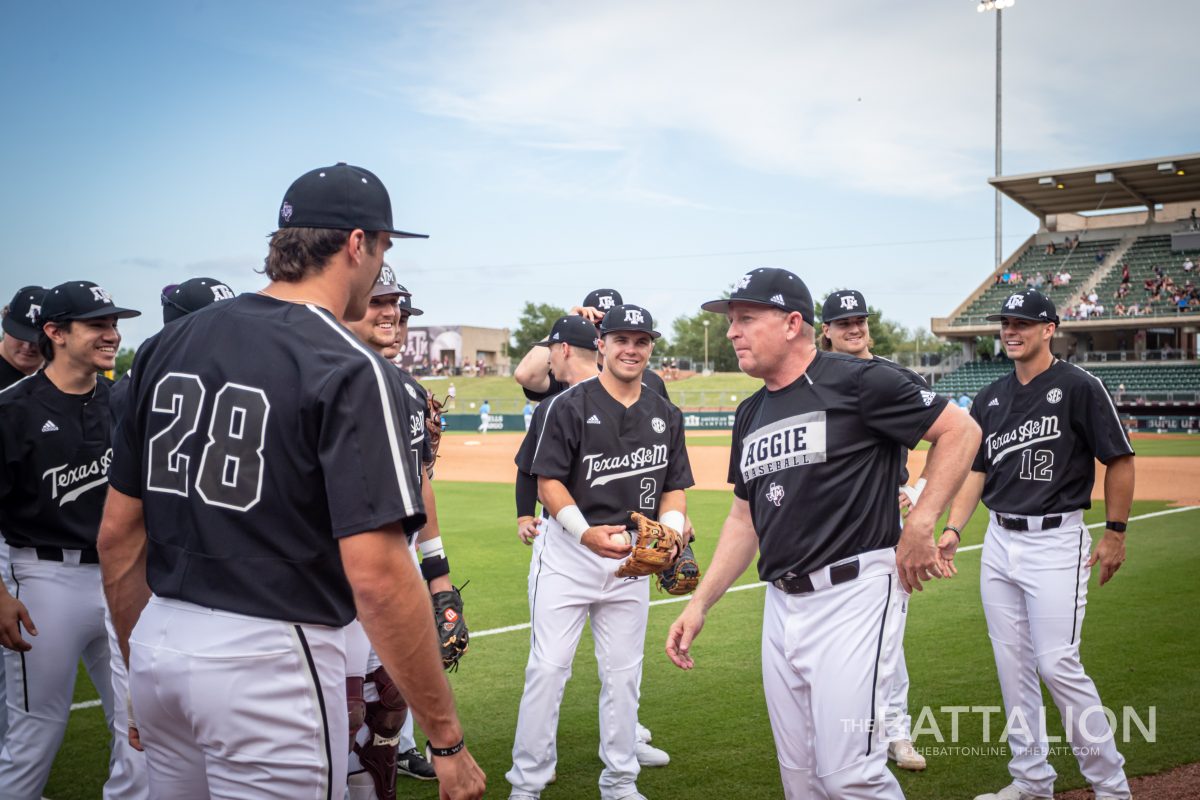 A&M coach Jim Schlossnagle speaks to his team while they warm up before their game against UT Arlington on Tuesday, May 3, 2022.