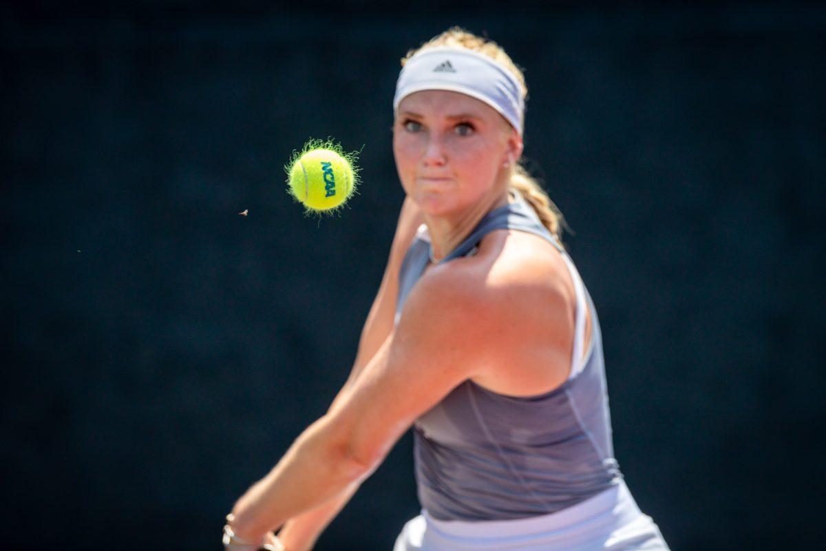 Senior Jayci Goldsmith hits a ball back to Leopoldine Boisseau during their singles match at the Mitchell Tennis Center on Friday, May 6, 2022.