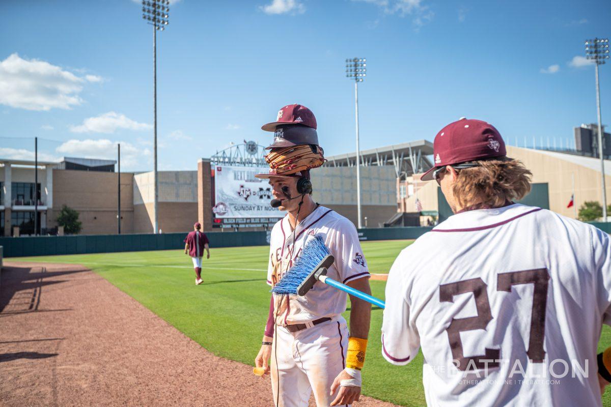 Graduate OF Dylan Rock (27) sweeps off junior 3B Trevor Werner (28) during his postgame interview.