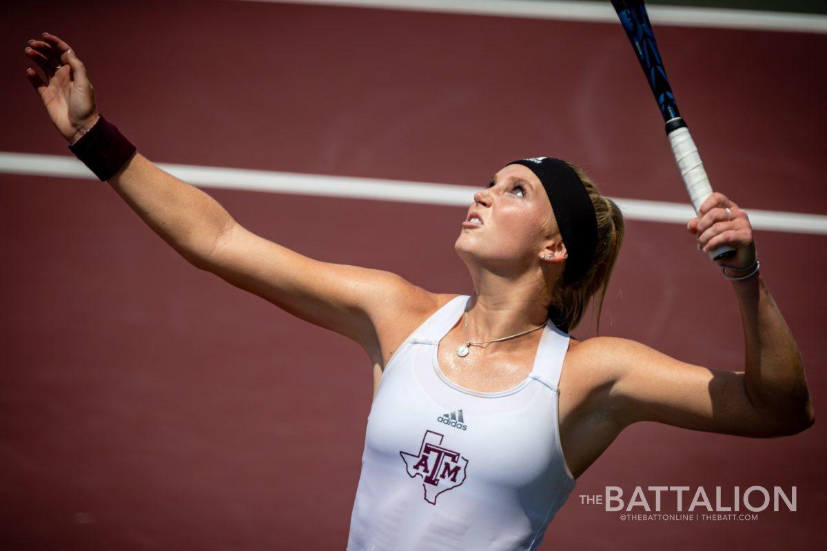 Senior Jayci Goldsmith serves the ball during her singles match at the Mitchell Tennis Center on Saturday, May 7, 2022.