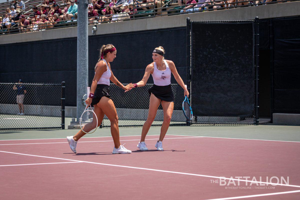 Graduate Tatiana Makarova celebrates with senior Jayci Goldsmith during their doubles match at the Mitchell Tennis Center on Saturday, May 7, 2022.
