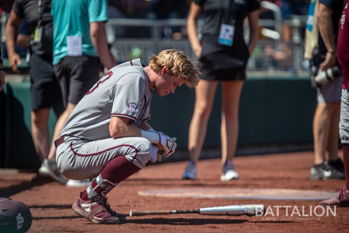 Junior RF Brett Minnich (23) sits by the dugout after the Aggies season was ended by the University of Oklahoma at Charles Schwab Field on June 22, 2022.