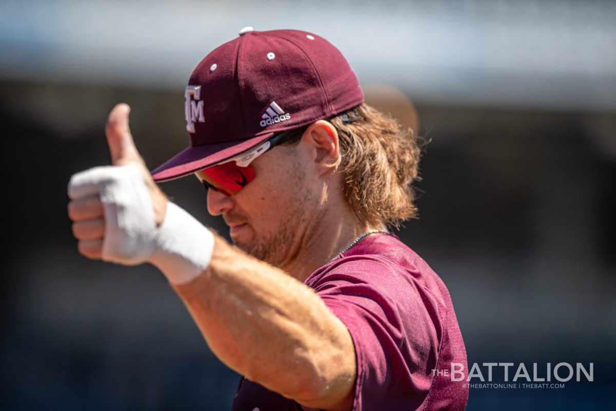 Graduate LF Dylan Rock (27) gives a thumbs up to some fans in the stands at Charles Schwab Field in Omaha, Nebraska on Wednesday, June 22, 2022.
