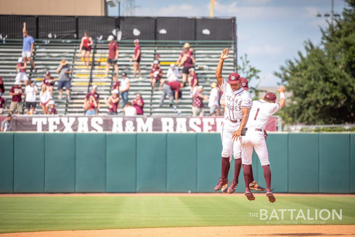 <p>A trio of Aggies celebrate their victory over Oral Roberts at Olsen Field on Friday, June 3, 2022.</p>