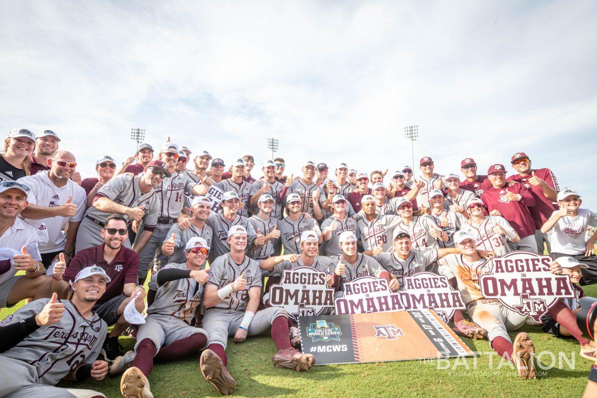 The Texas A&M baseball team huddles around its ticket to the College World Series after defeating Louisville on Saturday, June 11.