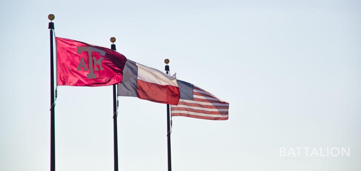 The Texas A&M, Texas state and American flags in front of the Texas A&M School of Medicine on Saturday, June 25, 2022. Bryan-College Station faces record-breaking high temperatures, placing intense strain on state and local power grids.