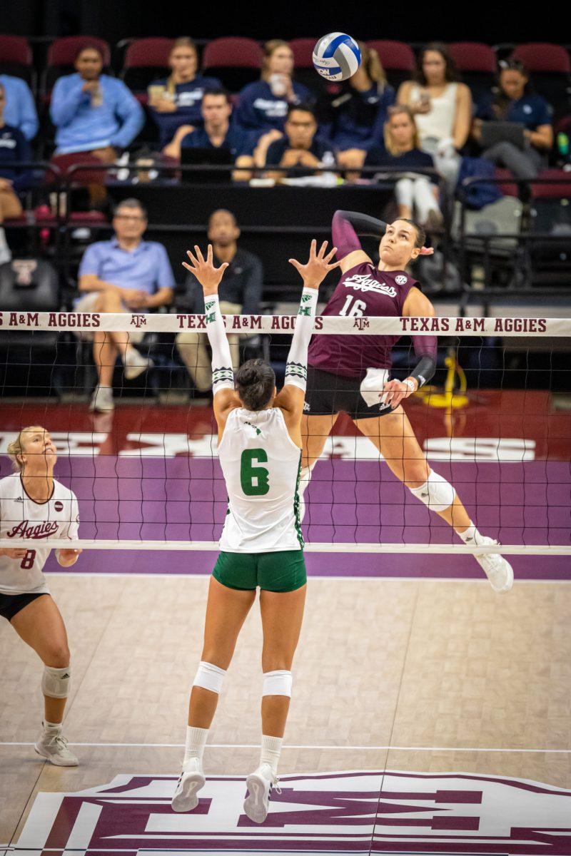 Graduate OH Caroline Meith (16) jumps to spike the ball during the Aggies' game against Hawai'i in Reed Arena on Friday, Aug. 26, 2022.