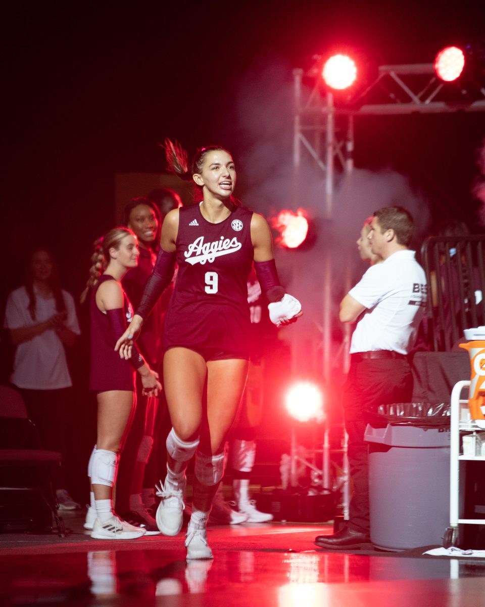 Freshman OPP Logan Lednicky (9) runs out onto the court before the start of the Aggies game against Hawaii in Reed Arena on Friday, Aug. 26, 2022.
