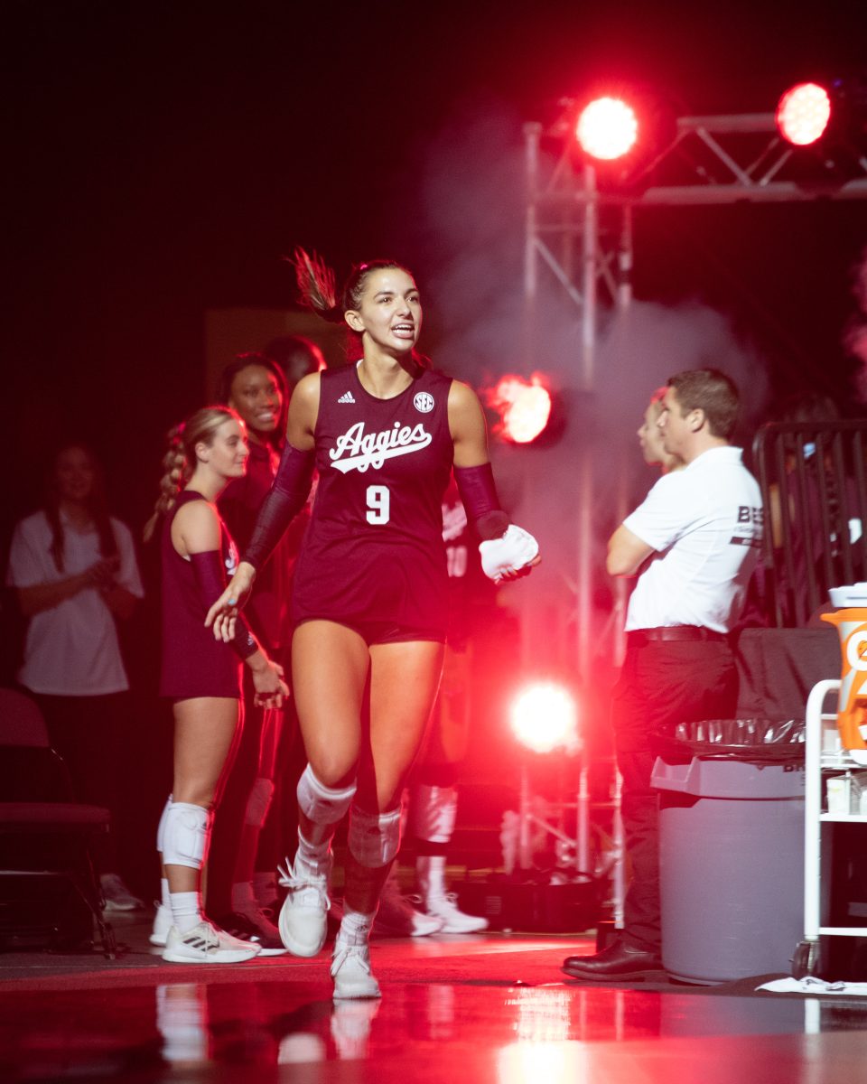 Freshman OPP Logan Lednicky (9) runs out onto the court before the start of the Aggies' game against Hawai'i in Reed Arena on Friday, Aug. 26, 2022.