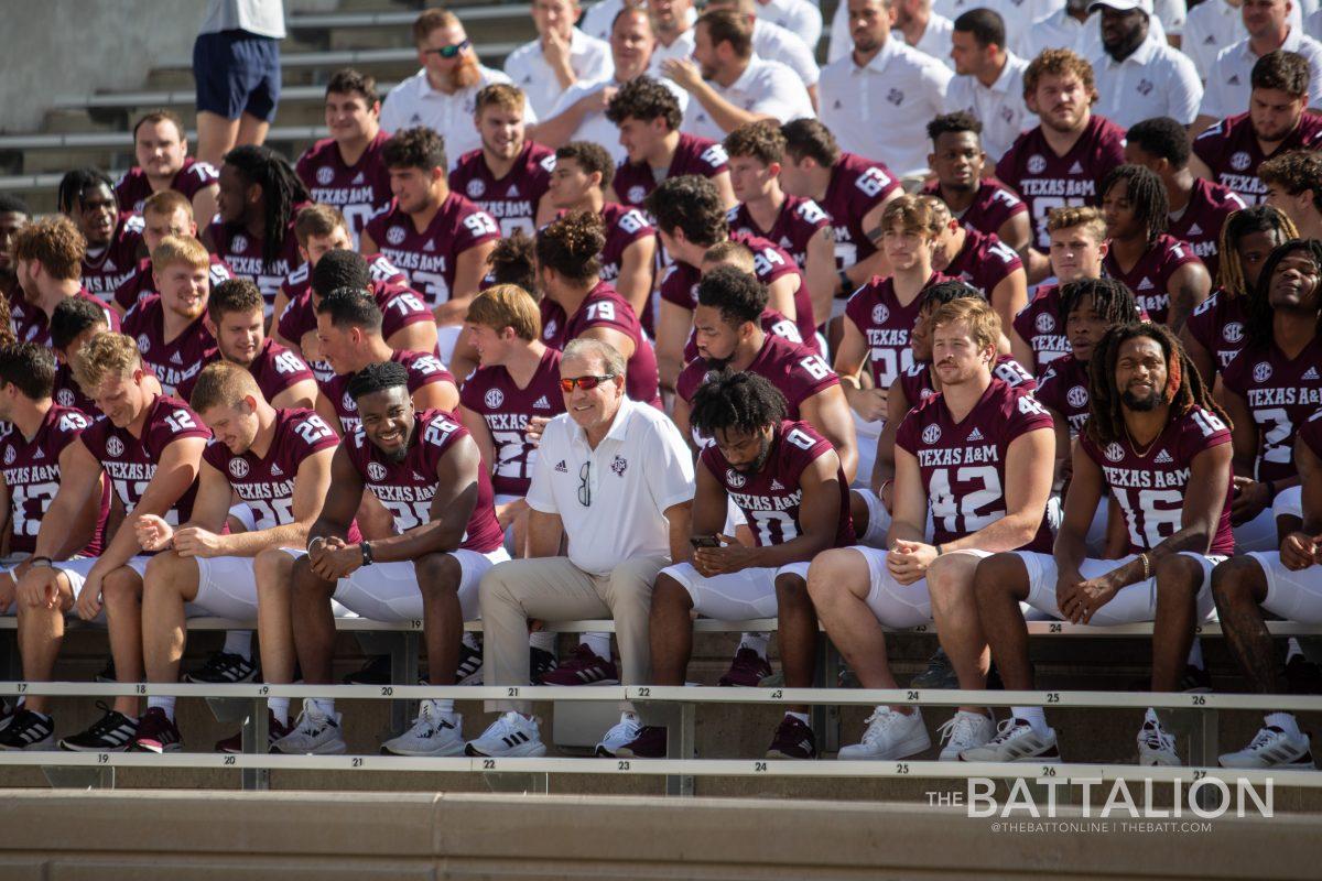 Coach Jimbo Fisher sits with the 2022-2023 Texas A&M Football team before taking the team photo at Kyle Field on Sunday, August 7, 2022.