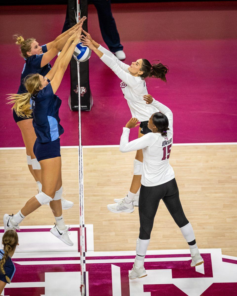 Graduate S Elena Karakasi (6) hits a ball blocked by San Diego during the Aggies match against San Diego on Saturday, Aug. 27, 2022 at Reed Arena.