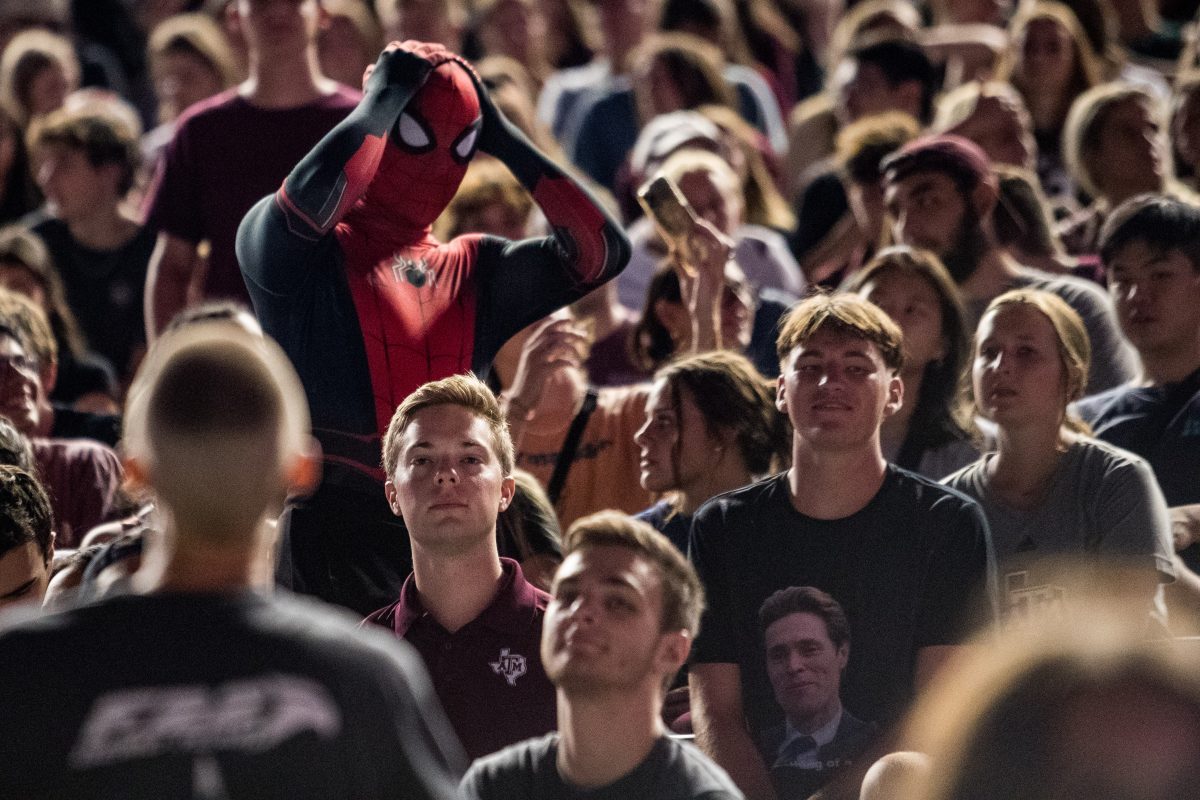 <p>An audience member in a Spider-Man costume reacts to another audience member with a Norman Osborn t-shirt at Kyle Field on Friday, Sept. 16, 2022.</p>